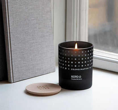 Skandinavisk KOTO 'Home' Scented Candle. Fragrance Notes: Vanilla Beans and Dried Orange Peel, Amber and Leather. 7.0 oz.